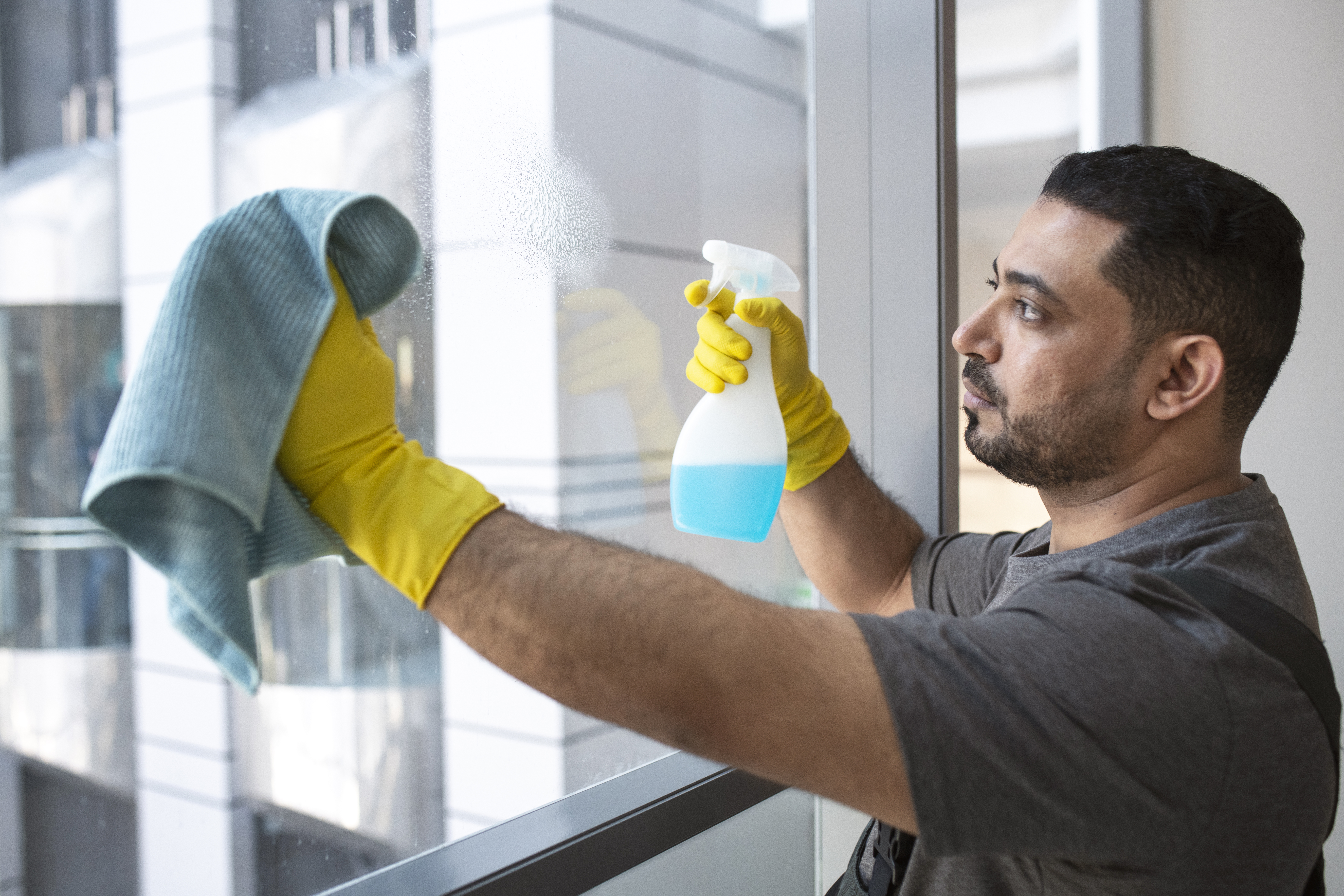 medium-shot-man-cleaning-office-window